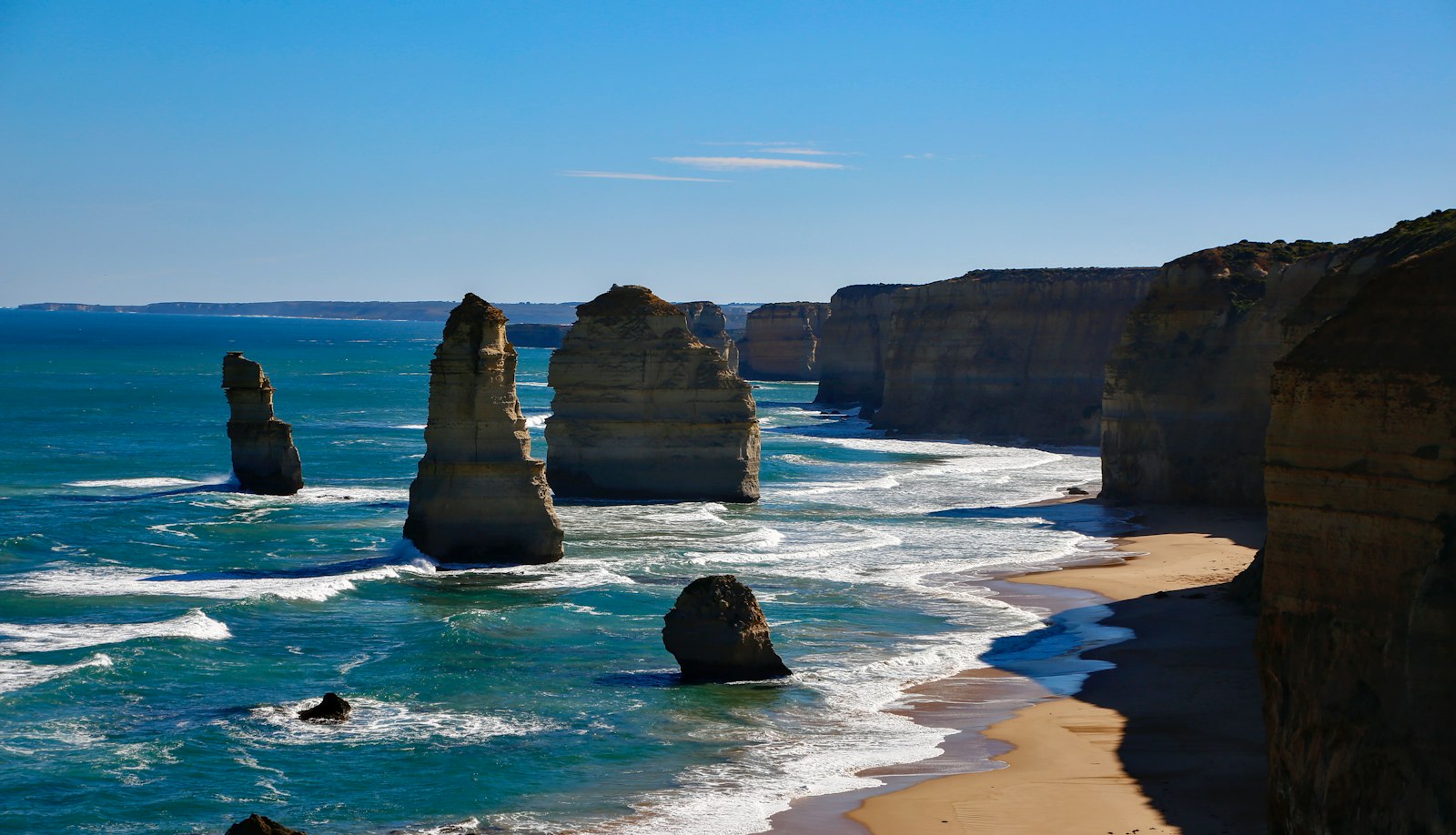Sea cliffs and rock stacks on a bright coastal day